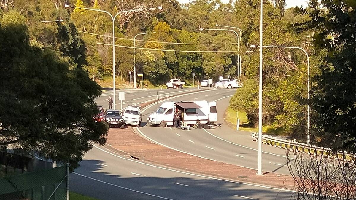 INVESTIGATION: Specialist police officers investigate a suspicious item at Capalaba. Photo: Helen Duggan