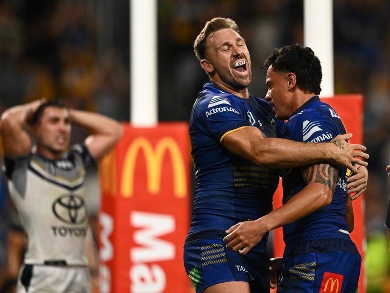 Bryce Cartwright (left) congratulates Daejarn Asi on his match-clinching try for the Eels. (James Gourley/AAP PHOTOS)